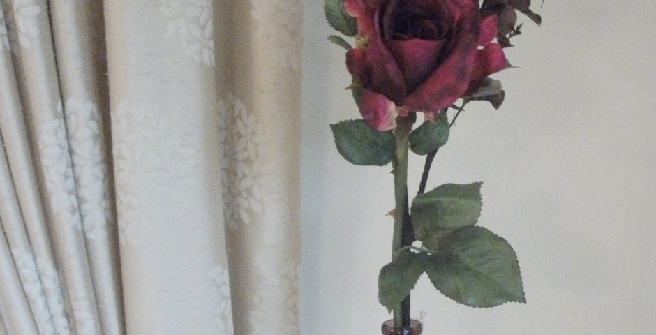 Z113 Tall cranberry coloured vase with large cranberry roses and eucalyptus